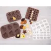 A collection of silicone baking molds and some baked goods on a light wooden surface. Produktbild-Vorschau