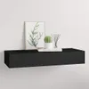 A black floating shelf mounted on a white wall, decorated with a framed picture, a small potted cactus, and a diffuser with reeds. Náhľad obrázku produktu