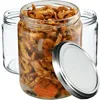 Three glass jars, one filled with pickled mushrooms and carrots, and a lid, on a white background. Produktbild-Vorschau