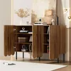 A wooden sideboard with wavy doors is displayed in a room with a painting and decorative items. Voir les images du produit