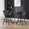 Two dark gray bar stools are arranged around a small round table in a modern setting with a bookshelf in the background. Produktbild-Vorschau