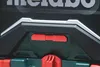 A close-up view of the control panel of a Metabo Akku-Baustellenradio, showing the USB and AUX input ports. Podgląd zdjęcia produktu