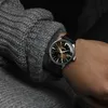 A close-up shot of a person's wrist wearing a Seiko Presage watch, with a grey knitted sweater sleeve visible. Produktbild-Vorschau