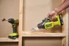 A hand is using a cordless vacuum cleaner to pick up sawdust from a wooden shelf. Podgląd zdjęcia produktu