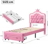 A pink upholstered bed frame with a crown-shaped headboard and integrated LED lighting, shown with dimensions and a separate diagram of a storage drawer. Voir les images du produit