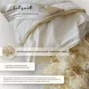 A close-up view of a pillow with its zipper partially open, revealing the filling. Produktbild-Vorschau