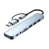 A silver USB-C hub with multiple ports and cables is shown against a white background. Produktbild-Vorschau