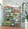 A bookshelf filled with plants and decorative items in a room with a concrete wall. Produktbild-Vorschau