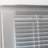 A close-up view of the top corner of a window blind. Produktbild-Vorschau