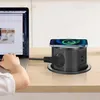 A person's hand is shown using a laptop next to a black retractable power outlet with a phone charging wirelessly on top. Produktbild-Vorschau
