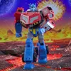 A Transformers action figure standing on a rocky, lava-like surface with a fiery, cosmic background. Anteprima dell’immagine prodotto