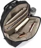 The interior of an open black backpack, showing organized compartments with a laptop, tablet, book, and phone. Voir les images du produit