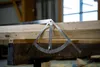 A metal angle measuring tool is placed on wooden beams in what appears to be a workshop or construction setting. Anteprima dell’immagine prodotto