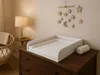 A nursery room with a changing pad on a dresser. Produktbild-Vorschau