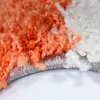A close-up view of the edge of a shaggy rug, showing the texture and colors of the fibers. Produktbild-Vorschau