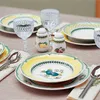 A table setting with plates, glasses, and salt and pepper shakers. Produktbild-Vorschau