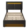 A black upholstered bed frame with a slatted mattress base and integrated LED lighting. Podgląd zdjęcia produktu