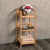 A bamboo shelf unit with items on it, placed against a textured wall. Produktbild-Vorschau