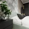 A bedroom scene with a bed, nightstand, and wallpaper. Produktbild-Vorschau