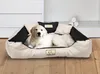 A golden retriever puppy lies in a beige and black dog bed. Voir les images du produit