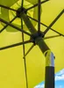Close-up view of the internal mechanism and fabric of a lime green umbrella. Produktbild-Vorschau