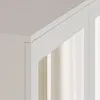 Close-up of the corner of a white cabinet with a mirrored door. Produktbild-Vorschau