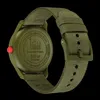 The back of a green watch with a fabric strap is shown against a black background. Voir les images du produit