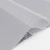 A close-up, studio shot of a rolled-up grey fabric blind with a striped pattern. Produktbild-Vorschau