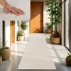A hallway with a long runner rug, plants, and wooden doors. Produktbild-Vorschau