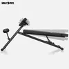 A black adjustable weight bench is shown from the side against a white background. The bench is angled, with the backrest slightly raised and the seat flat. There are ghosted images of the bench in different positions, indicating adjustability. Produktbild-Vorschau