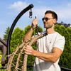 A man assembling a hanging chair outdoors. Produktbild-Vorschau
