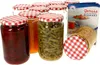 A collection of glass jars with red and white checkered lids, some filled with food items like beets, jam, and green beans, and a product box in the background. Produktbild-Vorschau