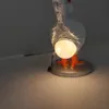 A close-up shot of a goose-shaped lamp with its light on. Podgląd zdjęcia produktu