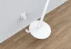 A white floor lamp base and power cord plugged into a wall outlet. Anteprima dell’immagine prodotto