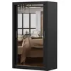 A black sliding door wardrobe with mirrored doors, reflecting a bedroom interior. Produktbild-Vorschau