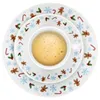 A top-down view of a stack of Christmas-themed plates with a cup of coffee on the top plate. Produktbild-Vorschau
