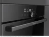 Close-up of a modern built-in oven's control panel and handle. Voir les images du produit