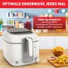 A white Tefal deep fryer is shown on a wooden countertop, with a kitchen background. There are french fries and onion rings in bowls next to it. Produktbild-Vorschau