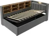 A bed frame with a headboard featuring shelves and a lift-up mattress base revealing storage. Podgląd zdjęcia produktu