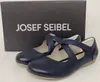 A pair of navy blue Mary Jane shoes with a box in the background. Voir les images du produit