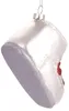 A white glass Christmas ornament shaped like a baby shoe with silver glitter on the sole and a red bow detail. Voir les images du produit