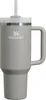 A gray Stanley tumbler with a straw and handle, shown against a white background. Produktbild-Vorschau