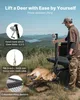A man is using a game hoist to lift a deer next to a pickup truck in a natural outdoor setting. Podgląd zdjęcia produktu