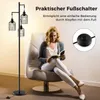 A woman is reading a book while sitting in a chair next to a floor lamp. Podgląd zdjęcia produktu