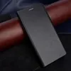 A black flip cover phone case is shown on a textured background of brown and dark blue materials. Produktbild-Vorschau