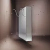 A side view of a cabinet with a mirror on the right side, mounted on a wall. There is a white cable connected to the back of the cabinet. Náhled obrázku produktu