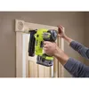 A person is using a cordless nail gun to attach trim to a door frame. Anteprima dell’immagine prodotto