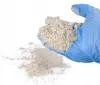 A gloved hand holding a powder. Produktbild-Vorschau