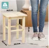 A person's legs and feet are shown next to a wooden stool, with dimensions indicated by text overlays. Voir les images du produit