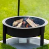 A fire pit with burning logs on a grassy lawn. Produktbild-Vorschau